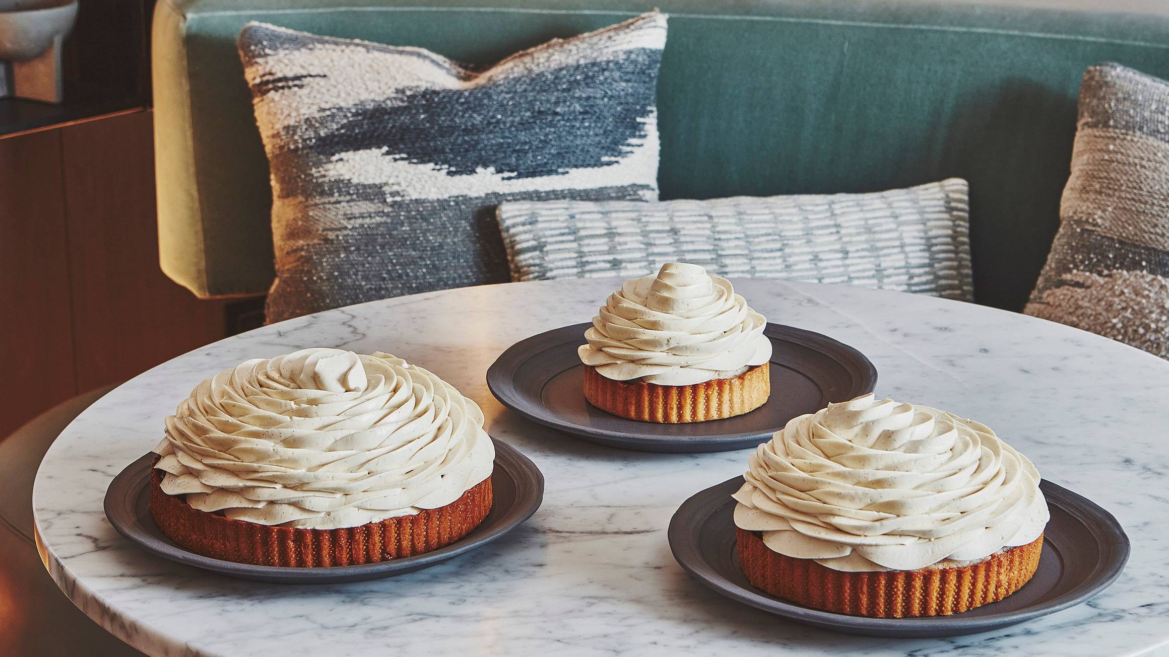 Cedric Grolet cakes sitting on a marbe table