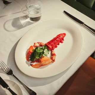 Maybourne red lobster on a plate with a knife and fork