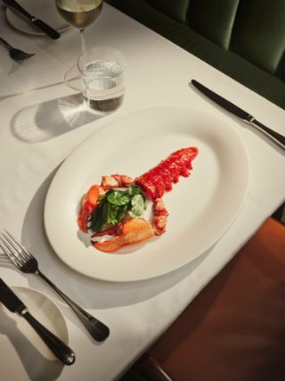 Maybourne red lobster on a plate with a knife and fork